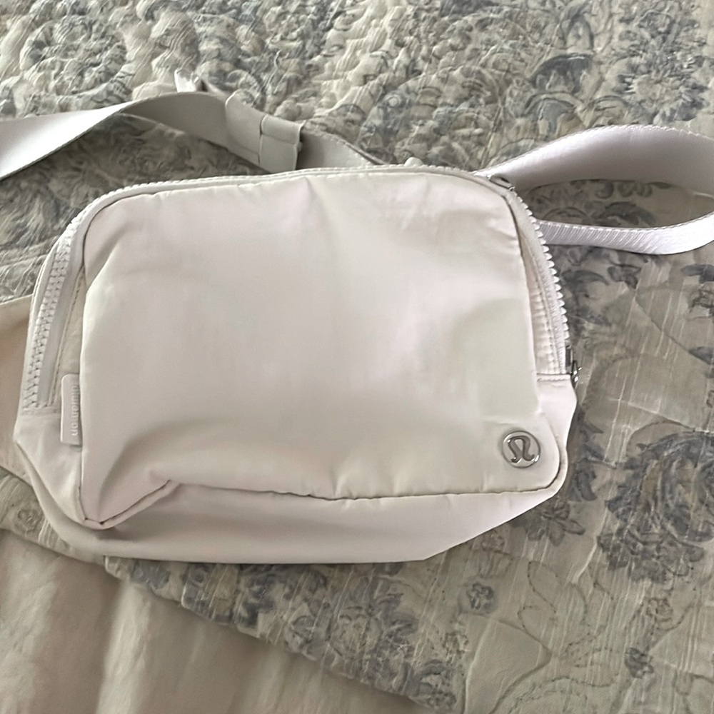It is a cream belt bag from lululemon and it is the normal size belt bag?